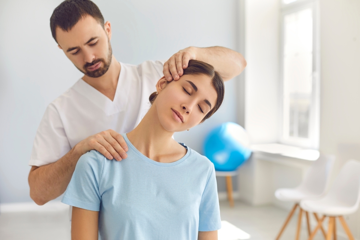 Finding Relief From TMJ_ Best Proven Treatments Vs Common Myths Male dentist performing neck and shoulder adjustment on female patient in modern dental clinic.