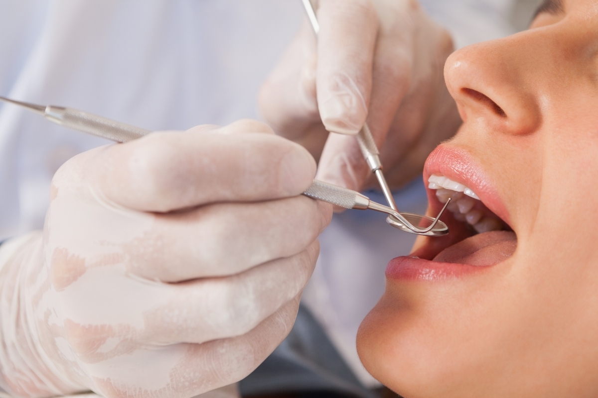 Dentist performing cosmetic bonding procedure on patient's teeth in Duxbury, MA.