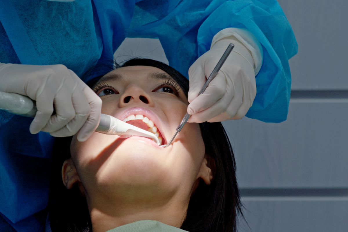 Dentist examining patient's teeth during preventive dental checkup in Duxbury.